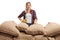 Female farmer behind a pile of burlap sacks