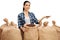 Female farmer with burlap sacks giving coffee beans