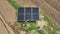 Female farmer cleaning solar panels in farm