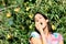 Female farmer eating fruit from pear tree