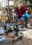 Female farmer feeds domestic ducks on shore of man-made pond in the backyard of farm