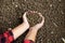 Female farmer hands holding handful of calf feed pellets