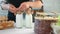 Female farmer hands packaging bottles of homemade milk tie rope. Close up shot on 4k RED camera