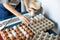 Female farmer hands packing eggs into paper tray from conveyor belt