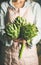 Female farmer holding fresh artichokes