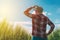 Female farmer looking at the sun on the horizon