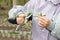 Female farmer with pruner shears the tips of raspberry bush