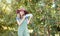 Female farmer recruiting workers to help with her startup. Happy young woman holding a hiring sign on a farm close to