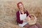 Female farmer sitting wheat agricultural field Woman baker holding wicker basket bread product