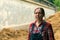 Female farmer standing in front of the horse manure pile