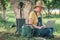 Female farmer using laptop computer in walnut orchard, innovative technology in organic farming