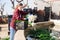 Female farmer washes green onions before selling in market