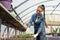 Female farmer working in large greenhouse. Organic food.