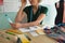 Female fashion designer checking color shade on a table in design studio