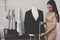 Female fashion tailor measuring office suit jacket