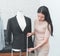 Female fashion tailor measuring office suit jacket