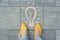 Female feet with abstract image drawing of light bulb written on grey sidewalk