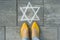 Female feet with abstract image of six pointed star, written on grey sidewalk