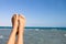 Female feet against the sea