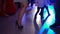 Female feet in black shoes dancing on the dance floor in a club