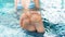 Female feet close-up on the background of the pool. Funny photo of feet in clear blue water. Fungal nail infections absence. The