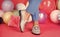 female feet in comfortable shoes loafers at colorful balloons, fashion