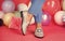 female feet in comfortable shoes loafers at colorful balloons, fashion