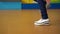 Female feet dancing breakdance on the dance floor, Close-up shot of dancing feet in white sneakers