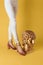 Female feet head sculptures golden color luxury fashion yellow background