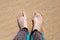 female feet with an increase in the joint of the big toe on the right foot, on the sand. Causes of the disease and