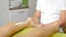Female feet massage. Close-up. Unrecognizable male therapist master hands making foot reflexology massage at beauty spa