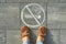 Female feet with picture no smoking painted on the grey sidewalk