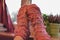 Female feet in pink woolen socks by the window, retro style tonal correction photo filter