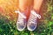 Female feet in polka-dot shoes .Woman sitting on the grass and enjoy .Sunny day.Outdoor