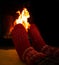 Female feet in red woolen socks by a warm fireplace on a cold winters evening