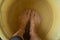 Female feet in soapy water, washing in a plastic bowl