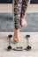 Female feet step on floor scales close up. Woman measuring her body weight by standing on electronic bathroom scale