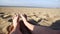 Female feet sunbathing on the beach