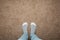 Female feet in warm socks against a background of brown carpet, space for text