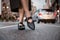 Female feet wear elegant leather shoes. Woman feet wearing high-heels on city street