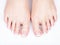 Female feet with white french pedicure on nails. at spa salon