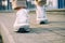 Female feet in white sneakers walking on the sidewalk