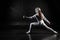 Female fencer on black background