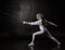 Female fencer isolated on black background