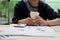 Female financial worker sipping coffee while examining her financial paperworks