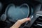 female finger presses the start stop engine button on a car dashboard. close-up, soft focus, in the background the dashboard and