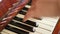 Female fingers playing keys on retro piano keyboard. Shallow depth of field. Focus on piano keys