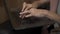 Female fingers writing a text, on black keyboard on laptop