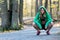 Female fitness model in sports bra with hoodie on nature trail.