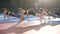 Female fitness team on outdoor stadium doing plank during sport workout in the green park in day time